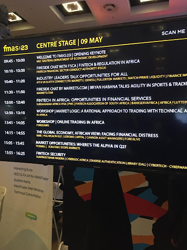 A digital monitor displaying the Finance Magnates Africa Summit line up of industry talks for day 1 of the conference.